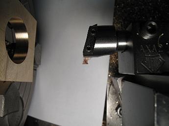 CrabWaterPumpModifications9Sept09 008 Boring the strap with a special profile tool which will allow us to turn an inside groove.  The small HSS toolbit is held in a small boring bar, which is held in the Aloris AXA quick-change tool holder.